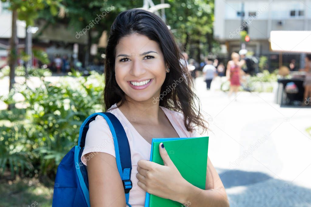 Single female student looking at laughing at camera
