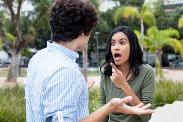Shocked young woman with boyfriend — Stock Photo, Image