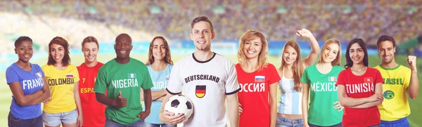 German soccer fan at stadium with group of fans from other count