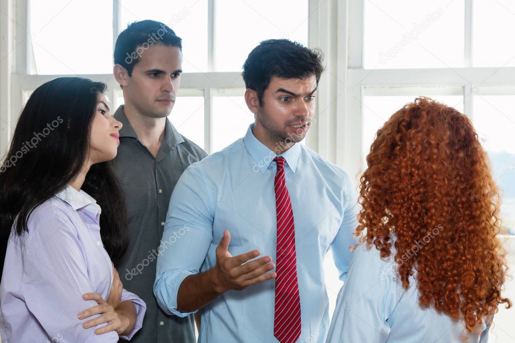 Angry boss talking to lazy employee