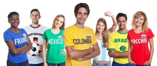 Lachender kolumbianischer Fan mit jubelnder Gruppe anderer Fans — Stockfoto