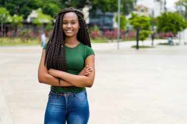 Laughing african american young adult woman with amazing hairsty