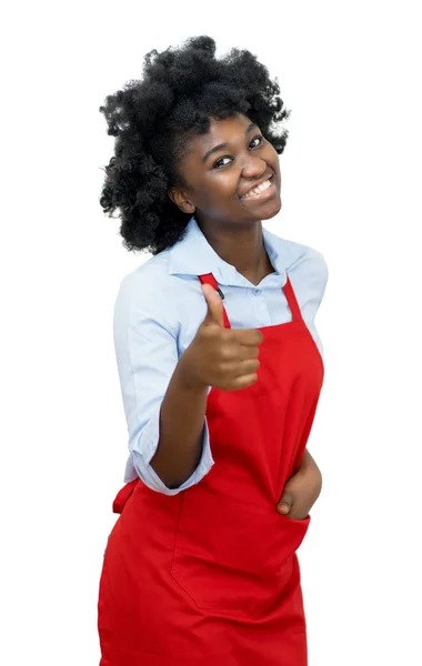 Afrykańska kelnerka w czerwonym fartuchu z kciukiem w górze — Zdjęcie stockowe