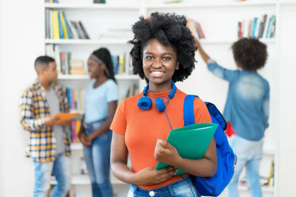 Beautiful african american female student with group of students — Stock Photo, Image