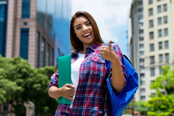 Hispanic female student in city showing thumb up — Stock Photo, Image