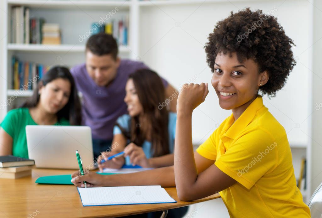 Laughing afro american female student with group of multi ethnic