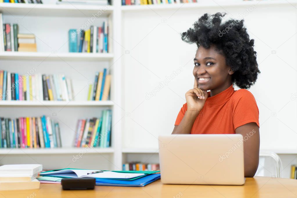 Beautiful african american young adult woman at computer at unibersity