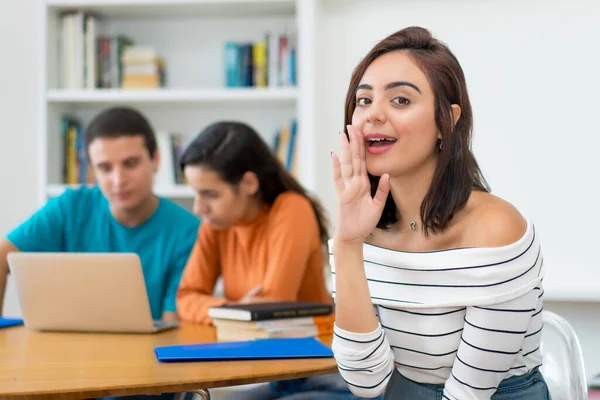 Young german female student with group of computer science students at classroom of university