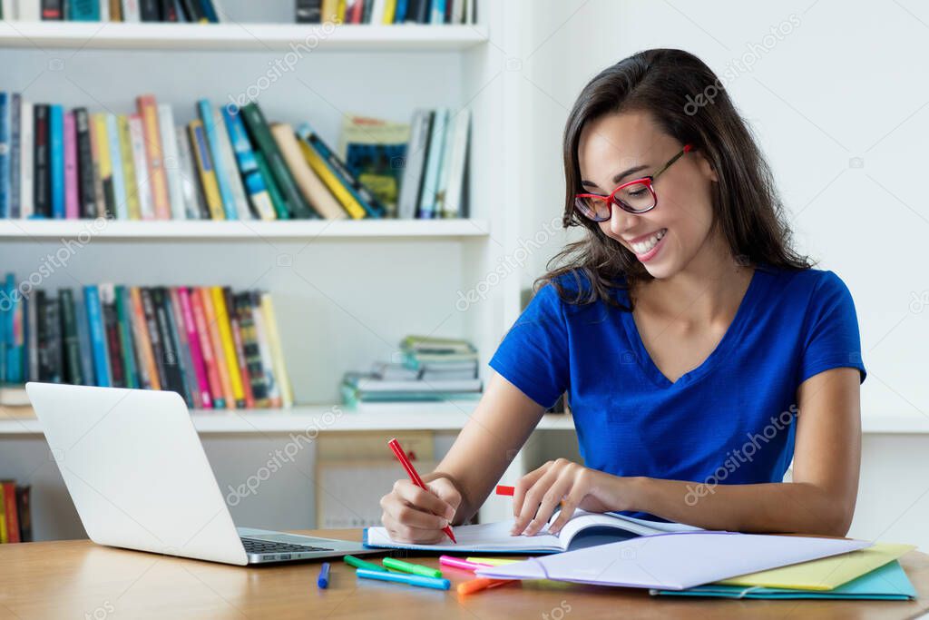 Nerdy female student learnig language and preparing for graduation at computer at home