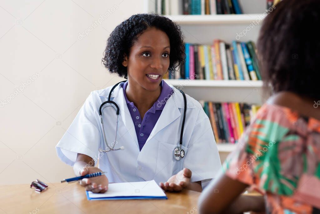 Mature african american female doctor recommending stay at home to patient at hospital