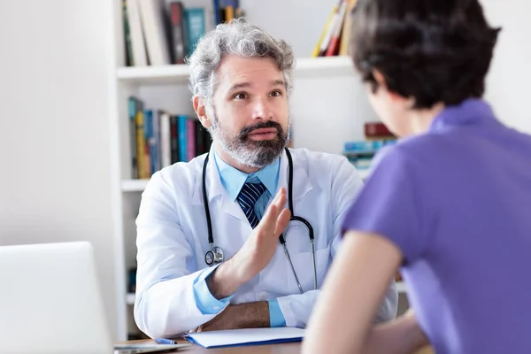 Mature Doctor Talking Patient Coronavirus Symptoms Hospital Clinic — Stock Photo, Image