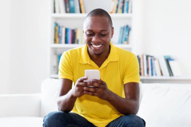 Evde cep telefonu olan Afrikalı Amerikalı bir adamın video çağrısı.