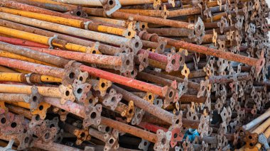 Background image of colorful scaffolding bar and wood used for construction stacked togeather