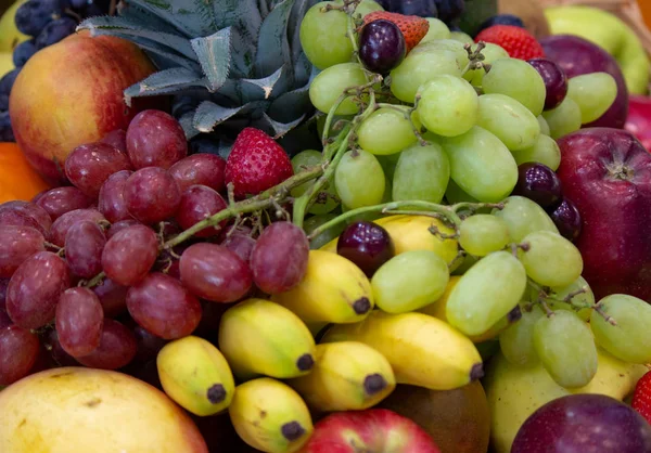 Achtergrond: Mix van gesorteerd vers fruit op een achtergrond — Stockfoto