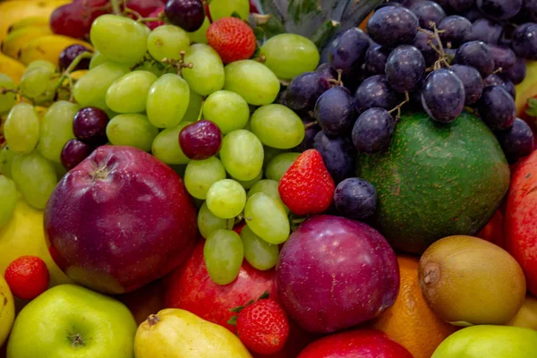 Achtergrond: Mix van gesorteerd vers fruit op een achtergrond — Stockfoto