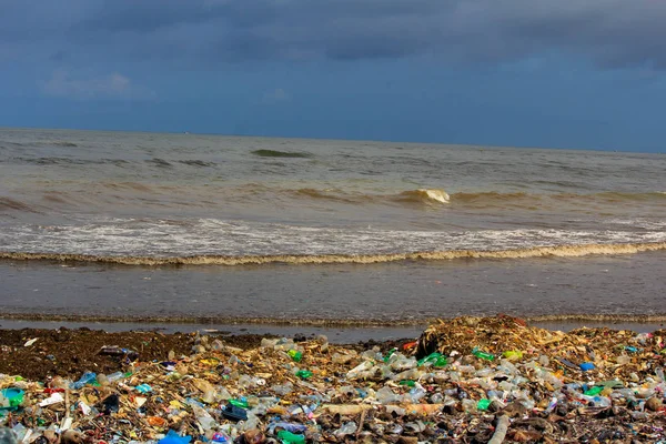 Inquinamento marino: rifiuti scaricati nel Mare dello Sri Lanka vicino a Colombo. le donne raccolgono cose di plastica in un mucchio di spazzatura portata dal surf dal mare — Foto Stock