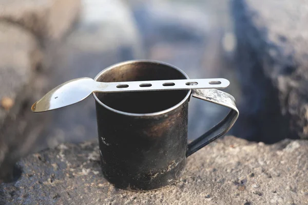 typical travel mug with a spoon. mug for camping in the mountains