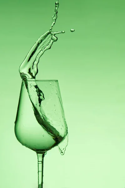 酒杯中美丽的水花，绿色滤清器，与复制空间紧密相连. — 图库照片
