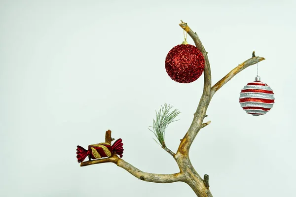 Modern Christmas. human footprint in ecology. So the Christmas tree can look out if we do not follow the ecology. dried Christmas tree with toys on a white background. with copy space — Stock Photo, Image