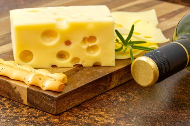 Piece of cheese close-up. cheese on a wooden board clipart