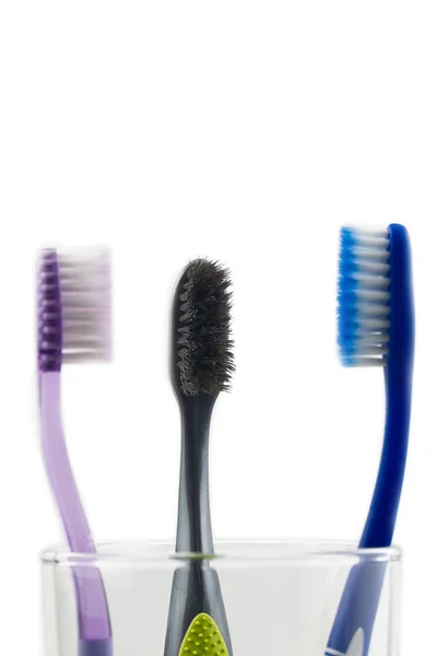 Toothbrushes in glass at bathroom isolated over white background. — Stock Photo, Image
