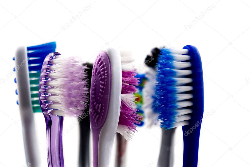 Toothbrushes in glass at bathroom isolated over white background.