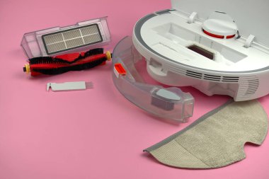 white robot vacuum cleaner on a pink background. The procedure for cleaning the robot vacuum cleaner after cleaning. future home technology. clipart