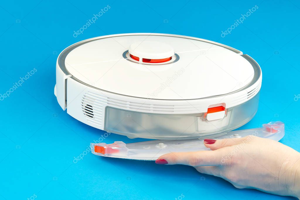robot vacuum cleaner isolated on blue background. mop replacement .close up photo