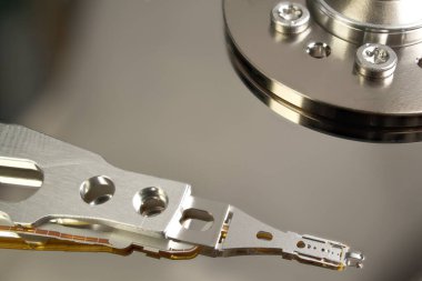 HDD. Inside of hard disk - magnetic disk with a reading head. close-up photo