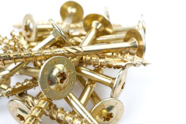 Gold torx screw isolated on white. Yellow zinc chipboard screw Torx, , full thread close up