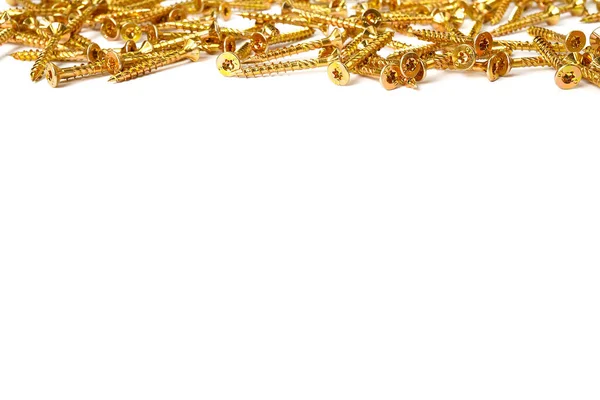 Gold screws scattered randomly on a white background. Torx yellow zinc head screws — Stockfoto