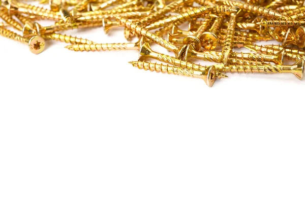 Gold screws scattered randomly on a white background. Torx yellow zinc head screws — Stockfoto