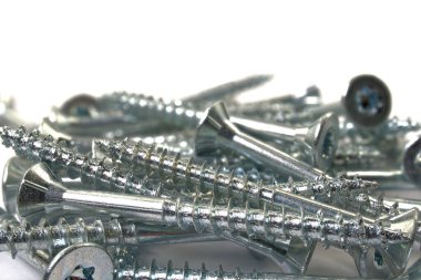 Torx screws on white background close up. Silver screws for wood, chipboard or plywood with torx head.