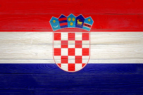 Croatia flag painted on old wood plank background. Brushed natural light knotted wooden board texture. Wooden texture background flag of Croatia.