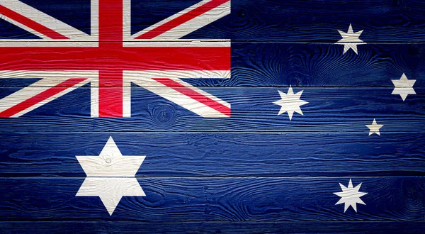 Australia flag painted on old wood plank background. Brushed natural light knotted wooden planks board texture. Wooden texture background flag of Australia