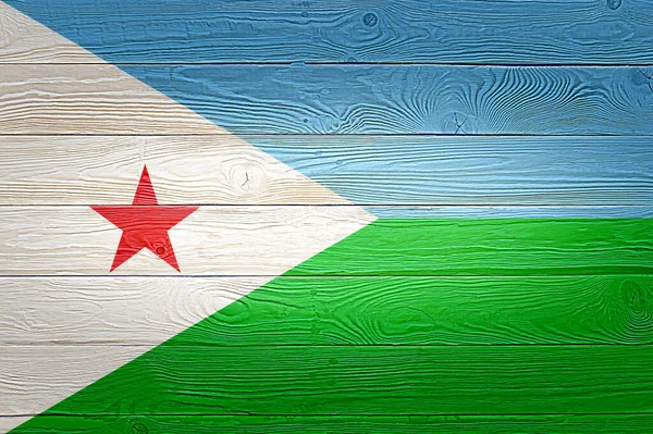 Djibouti flag painted on old wood plank background. Brushed natural light knotted wooden planks board texture. Wooden texture background flag of Djibouti