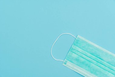 Yüz kalkanı, FFP1 NR seviyesi. Bakterilere karşı koruma, COVID-19, virüsler, koronavirüs. Tıbbi yüz maskesi N95 açık mavi üzerinde izole edilmiş.