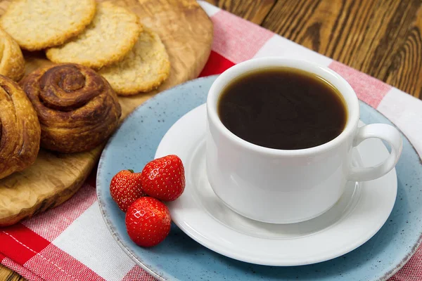 cup of coffee and bakery on old wooden table