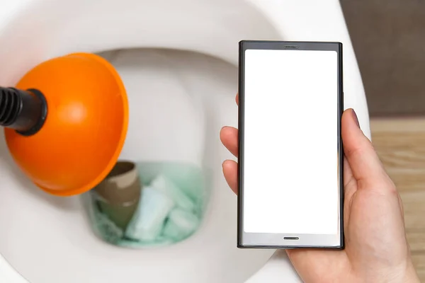 Cleaning service concept, woman searching for help in smartphone. mockup. do not throw foreign objects, sanitary pads, tampons, paper, plastic into the toilet. Close-up of a toilet bowl clogged — Stock Photo, Image