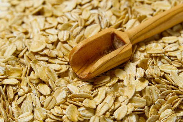 Close up of oats flakes. oats flakes macro shoot. Oatmeal flakes texture. Background of golden oat flakes. Healthy food.