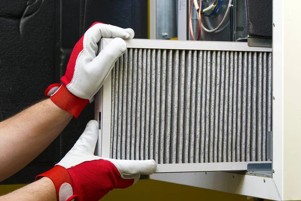 Replacing the filter in the central ventilation system. Replacing Dirty Air filter for home central air conditioning system. Change filter in rotary heat exchanger recuperator. — Stock Photo, Image