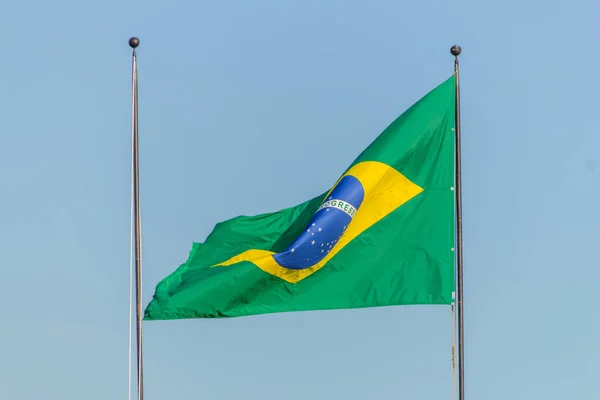 Brazilian flag flying with blue sky background — Stock Photo, Image