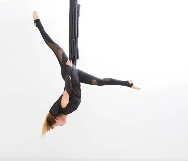 Young asia girl do fly yoga and stretches on white background. — Stock Photo, Image