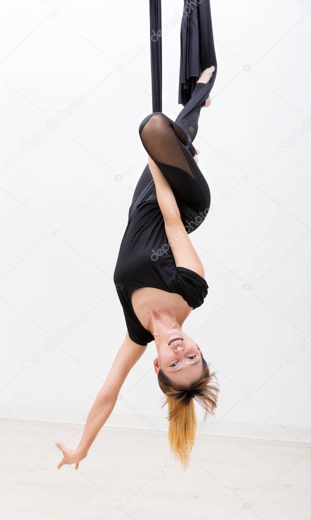 Young asia girl do fly yoga and stretches on white background.