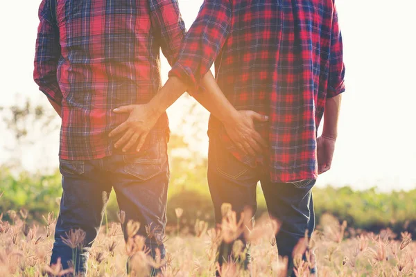 Cropped image of gay couple Catch the butt. — Stock Photo, Image