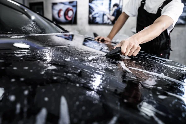 Close up of paint protection film installation on front bumper o — Stock Photo, Image