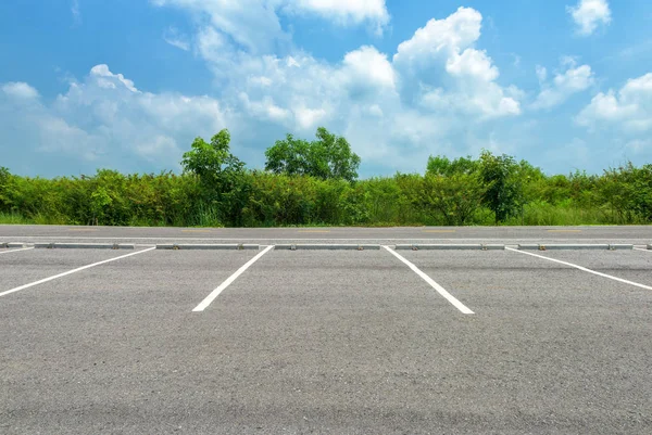 Empty parking lot on blue sky background — Stock Photo, Image