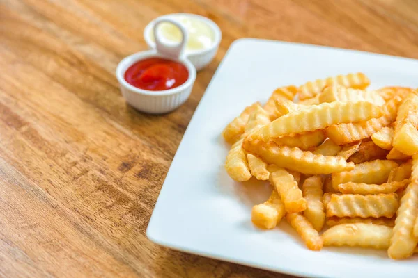 French fries with ketchup on wooden background. — Stock Photo, Image