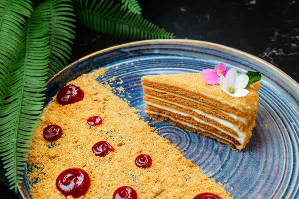 Cake honeycake with an unusual serving on a plate