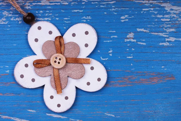 Decorative wooden flower on blue wooden background — Stock Photo, Image